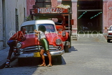 CUBA, Havana, old town, couple chatting by an old American car, CUB284JPL