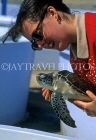 Cayman Islands, GRAND CAYMAN, Cayman Turtle Farm, tourist with turtle, CAY57JPL