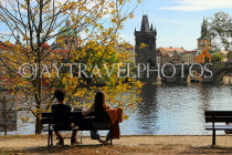Czech Rep, PRAGUE, River Vlatava, and two people on riverside bench, CZ1508JPL
