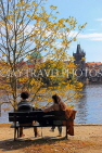 Czech Rep, PRAGUE, River Vlatava, and two people on riverside bench, CZ1509JPL