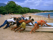 DOMINICAN REPUBLIC, North Coast, Playa Dorada beach, people pushing boat out, DR146JPL