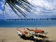 DOMINICAN REPUBLIC, North Coast, beach at Puerto Plata, Playa Dorada, couple on sunbeds, DR260JPL
