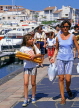 FRANCE, Languedoc-Roussillon, CAP DAGDE, girl carrying baguettes, FRA448JPL