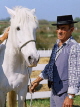 FRANCE, Languedoc-Roussillon, Camargue, cowboy with wild white horse, FRA421JPL