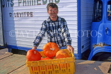 FRANCE, Normandy, Valognes, market trader with pumpkins, FRA110JPL