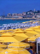 FRANCE, Provence, Cote d'Azure, CANNES, beach and parasols, Old Town in background, FRA224JPL