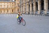 France, PARIS, cyclist riding by the Louvre Museum, FRA2112JPL