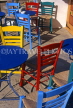 Greek Islands, ANAPHI, Aylos Nikolaos, brightly painted tables and chairs in cafe, GIS710JPL