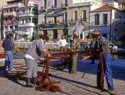 Greek Islands, CRETE, Agios Nikolaos, harbourfront, fishermen sorting out nets, GIS1195JPL