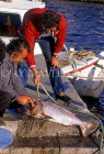 Greek Islands, CRETE, Agios Nikolaos, man scaling fish, GIS1126JPL