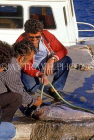 Greek Islands, CRETE, Agios Nikolaos, man scaling fish, GIS1201JPL