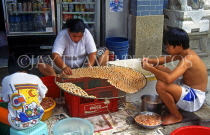 HONG KONG, Cheung Chau Island, two people spreading out shrimps for drying, HK522JPL