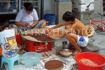 HONG KONG, Cheung Chau Island, two people spreading out shrimps for drying, HK523JPL