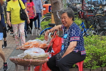 HONG KONG, Cheung Chau island, woman selling dried seafood, HK1549JPL