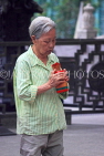 HONG KONG, Kowloon, Wong Tai Sin Temple, worshipper shaking Fortune Sticks, HK1162JPL