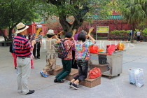 HONG KONG, Lantau Island, Po Lin Monastery, people praying with incense sticks, HK884JPL
