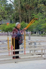 HONG KONG, Lantau Island, Po Lin Monastery, woman with large incense sticks, HK883JPL