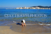 IBIZA, beach and seascape, West Coast, boy paddling, San Antonio in background, SPN1415JPL