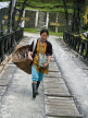 INDIA, Sikkim, Girl with her basket crossing a bridge, IND1478JPL