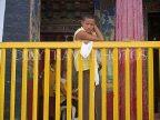 INDIA, Sikkim, monk standing by the railing of his monastery, IND1484JPL