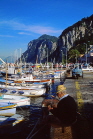 ITALY, Campania, Amalfi Coast, CAPRI, fishing boats along Marina Grande, man fishing, ITL1096JPL