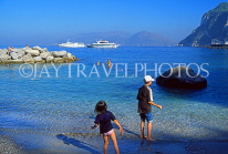 ITALY, Campania, Amalfi Coast, CAPRI, kids paddling on beach, near Marina Grande, ITL1101JPL