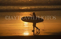 Indonesia, BALI, Kuta Beach, sunset, surfer walking along beach, BAL1266JPL