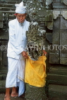 Indonesia, BALI, Pura Besakih Temple, worshipper by guardian statue, BAL1309JPL