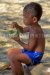 Indonesia, BALI, Sanur Beach, Balinese boy having a snack, BAL1060JPL