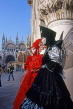 Italy, VENICE, Carnival, masquerade characters, couple in red and black costume, ITL1792JPL