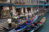 Italy, VENICE, canalside restaurant tables and gondolas, ITL1869JPL