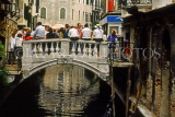 Italy, VENICE, small bridge over canal, and people seated on it, ITL1902JPL