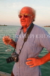 JAMAICA, Montego Bay, man (tourist) enjoying his wine, by the sea at sunset, JM322JPL