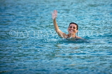 JAMAICA, Montego Bay, tourist enjoying her swim at sea, waving, JM382JPL