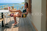 JAMAICA, Montego Bay, tourist enjoying the view from hotel balcony, JM356JPL