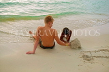 JAMAICA, Negril, 7 Mile Beach, tourist and boy, JM254JPL