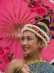 LAOS, Luang Prabang, Lao girl under red umbrella, dressed for Songkran New Year festival, LAO47JPL