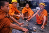 LAOS, Luang Prabang, Wat Wisunalat (temple), monks around fireplace, LAO37JPL