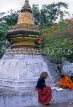 LAOS, Luang Prabang, Wat Xieng Thong (temple), monk and tourist by stupa, LAO42JPL