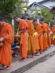 LAOS, Luang Prabang, monks making their morning alms rounds, LAO70JPL