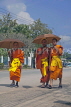 LAOS, Luang Prabang, young Buddhist monks, walking along road, LAO140JPL