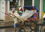 MADAGASCAR, Antisirabe, pousse pousse (rickshaw) and driver, in the rain, MDG219JPL