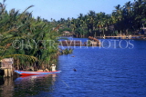MALAYSIA, Kota Bharu, lagoon with fisherman in boat setting traps, MSA414JPL