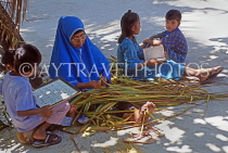 MALDIVE ISLANDS, Maafushi, local fishing island village, child with teacher, reading, MAL767JPL