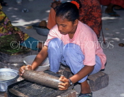 MALDIVE ISLANDS, Maafushi, local fishing island village, woman stone grinding spices, MAL547JPL