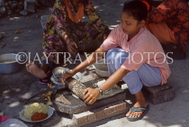 MALDIVE ISLANDS, Maafushi, local fishing island village, woman stone grinding spices, MAL760JPL