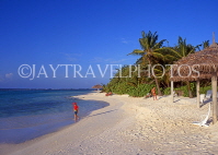 MALDIVE ISLANDS, Velassaru Island, beach and coconut trees, boy (tourist) paddling, MAL431JPL