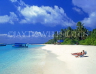 MALDIVE ISLANDS, Velassaru Island, sunbathers on beach, and island view, MAL416JPL