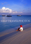 MALDIVE ISLANDS, beach and seascape, boy (tourist) seated on beach, MAL458JPL