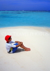 MALDIVE ISLANDS, beach and seascape, boy (tourist) seated on beach, MAL505JPL